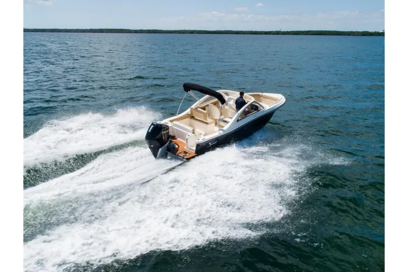Slide: The Image of 2023 Scout 240 Dorado boat cruising on open water. - 1