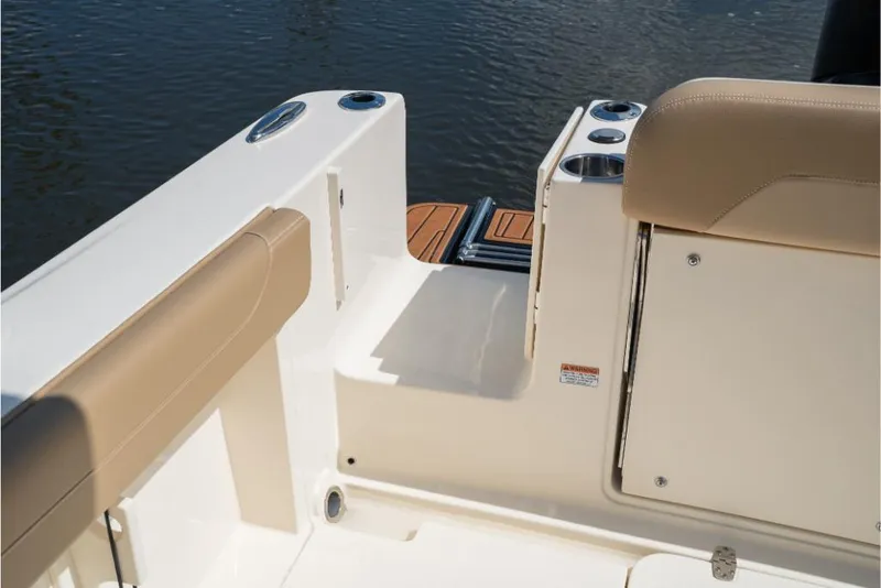 Slide: The Image of 2023 Scout 240 Dorado boat interior with tan seating and water view. - 12