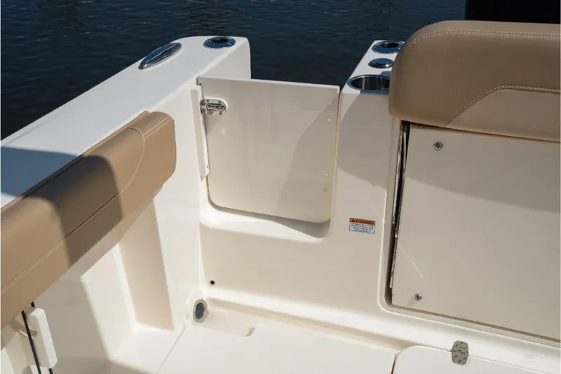 Slide: The Image of 2023 Scout 240 Dorado boat interior with beige seating and storage compartments. - 13