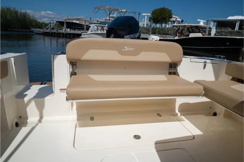 Slide: The Image of 2023 Scout 240 Dorado boat with tan seating and Mercury outboard motor. - 15