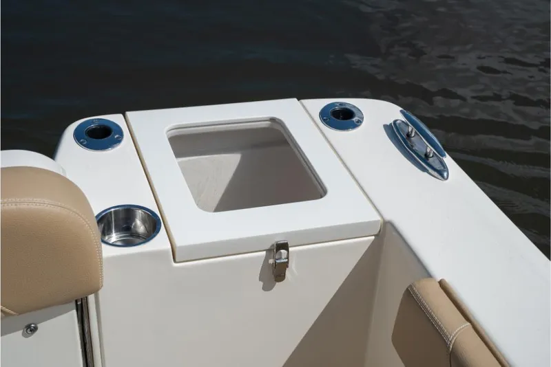 Slide: The Image of 2023 Scout 240 Dorado boat interior with storage compartment and cup holders. - 18