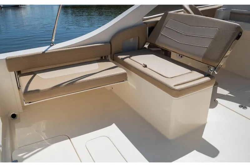 Slide: The Image of 2023 Scout 240 Dorado boat interior seating area with beige cushions. - 19