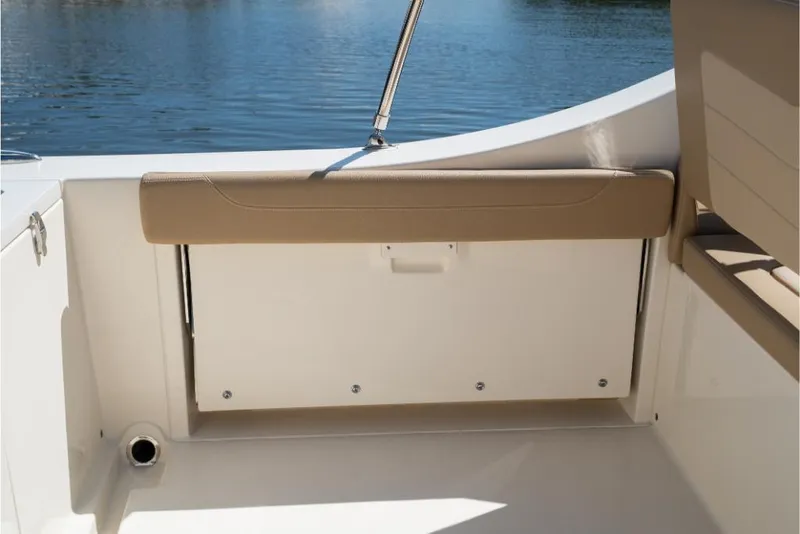 Slide: The Image of 2023 Scout 240 Dorado boat interior with tan seating and storage compartment. - 21