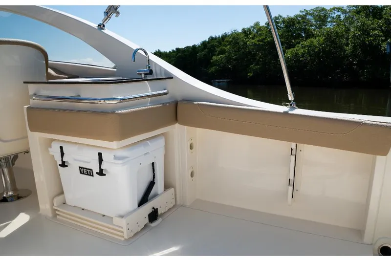 Slide: The Image of 2023 Scout 240 Dorado boat interior with Yeti cooler and sink. - 22