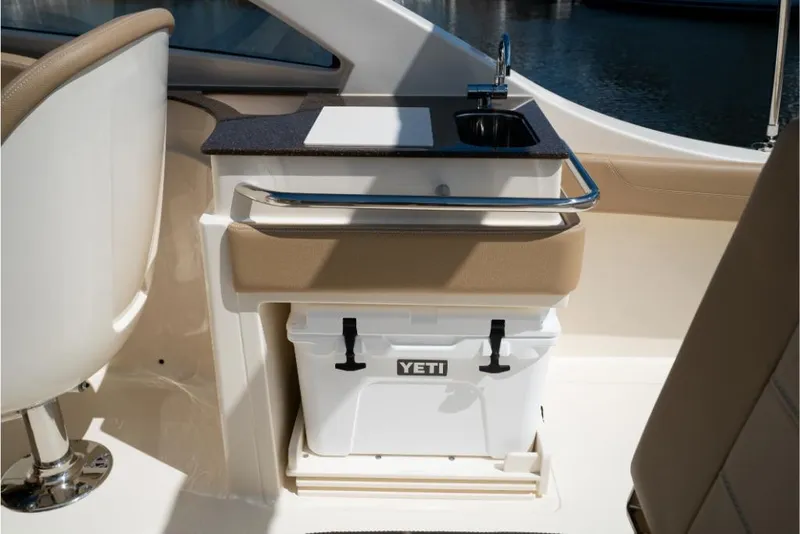 Slide: The Image of 2023 Scout 240 Dorado boat interior with Yeti cooler and sink. - 23