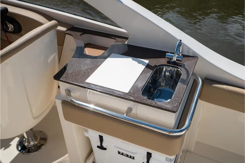 Slide: The Image of 2023 Scout 240 Dorado boat interior with sink and cutting board. - 24