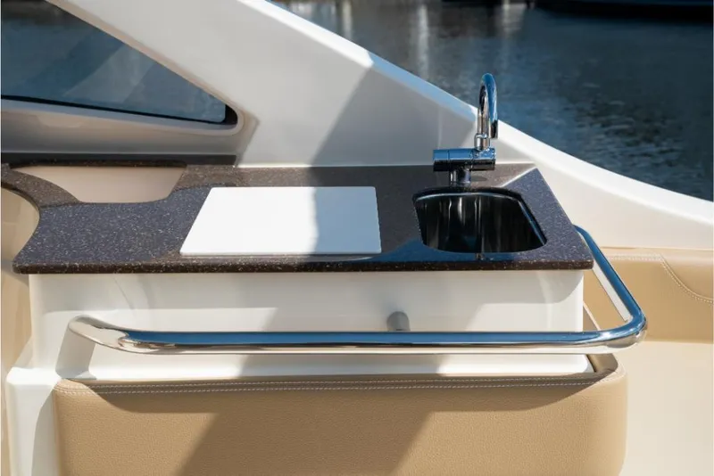 Slide: The Image of 2023 Scout 240 Dorado boat kitchenette with sink and cutting board. - 25