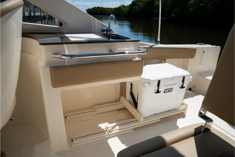 Slide: The Image of 2023 Scout 240 Dorado boat interior with Yeti cooler and sink. - 27