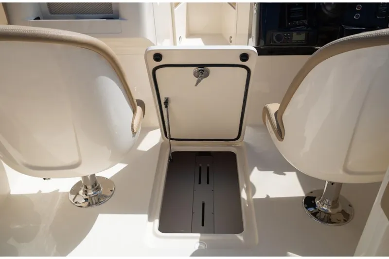 Slide: The Image of 2023 Scout 240 Dorado boat interior with storage compartment and seating. - 29