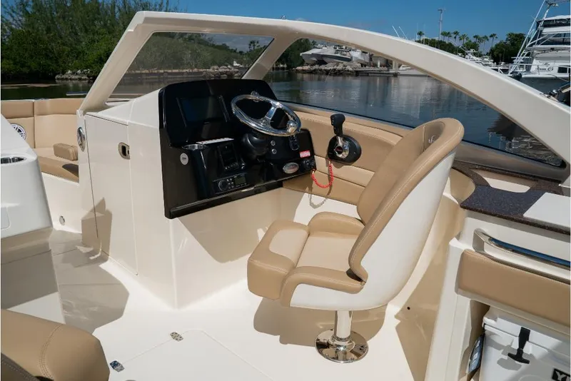 Slide: The Image of 2023 Scout 240 Dorado boat interior with helm station and captain's chair. - 31