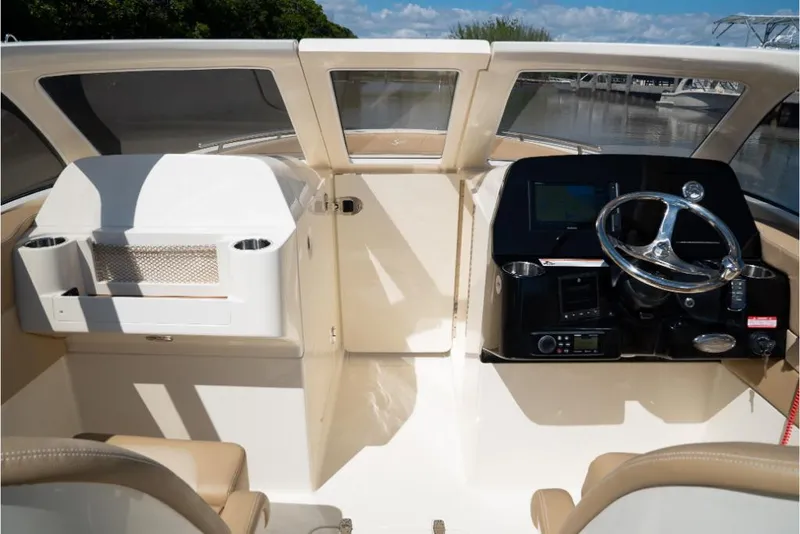Slide: The Image of 2023 Scout 240 Dorado boat cockpit with steering wheel and dashboard. - 32