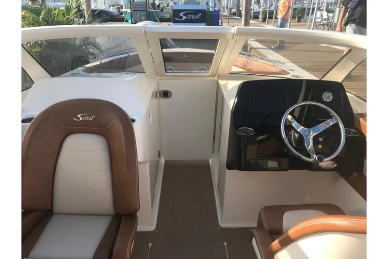 Slide: The Image of 2023 Scout 240 Dorado boat interior with steering wheel and seating. - 33