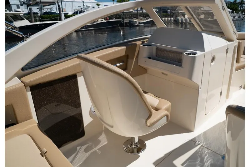 Slide: The Image of 2023 Scout 240 Dorado boat interior with helm seat and dashboard. - 36