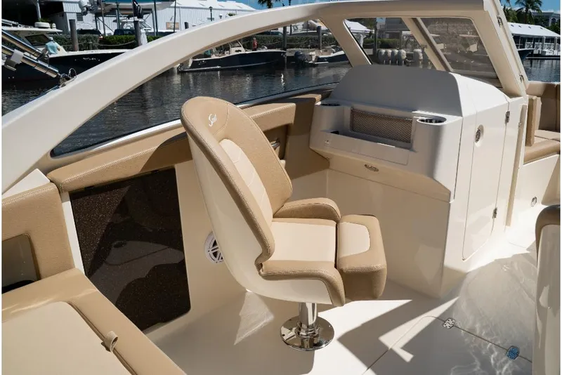 Slide: The Image of 2023 Scout 240 Dorado boat interior with beige seating and helm station. - 38