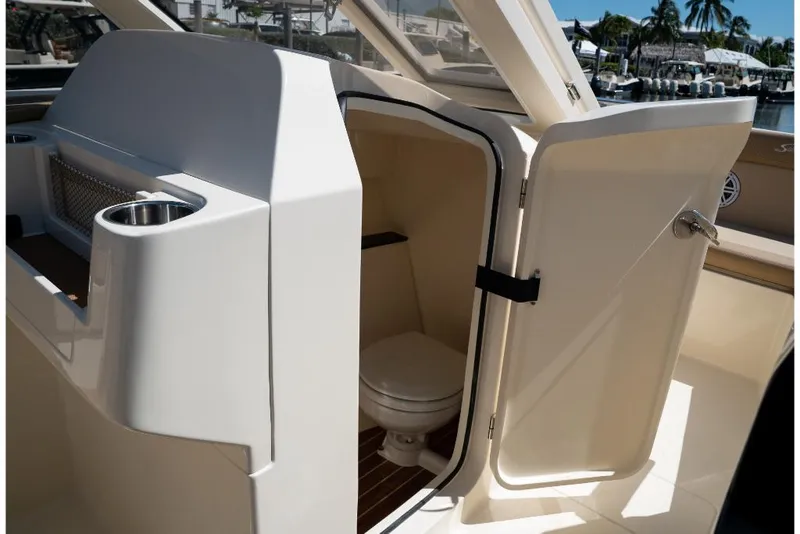 Slide: The Image of 2023 Scout 240 Dorado boat interior with open door revealing toilet. - 41