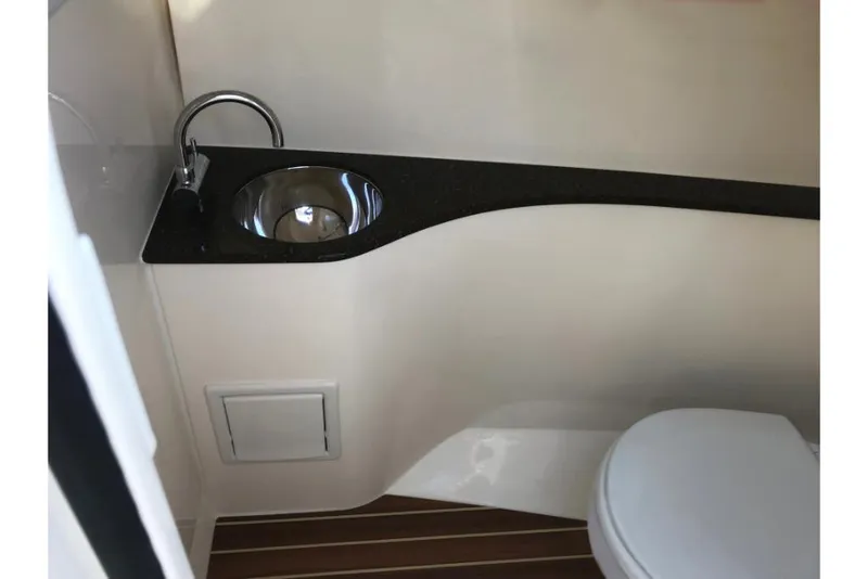 Slide: The Image of 2023 Scout 240 Dorado boat interior bathroom with sink and toilet. - 45
