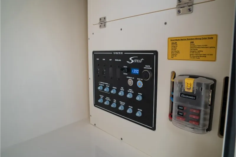 Slide: The Image of Control panel of a 2023 Scout 240 Dorado boat with electronic switches. - 47