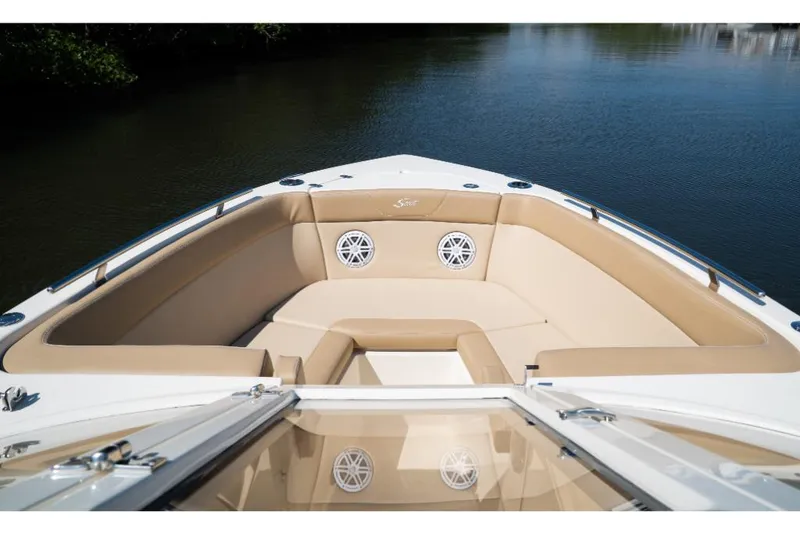Slide: The Image of 2023 Scout 240 Dorado boat with tan seating and speakers on the bow. - 49