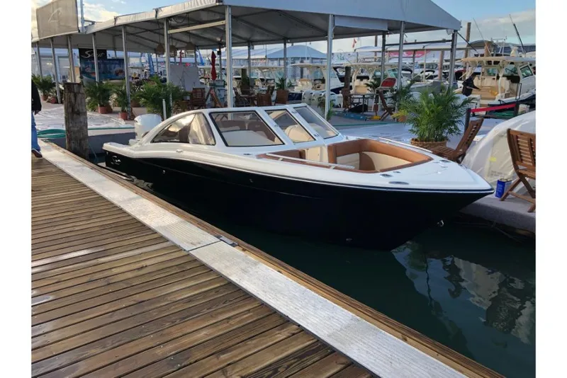 Slide: The Image of 2023 Scout 240 Dorado boat docked at a marina. - 6