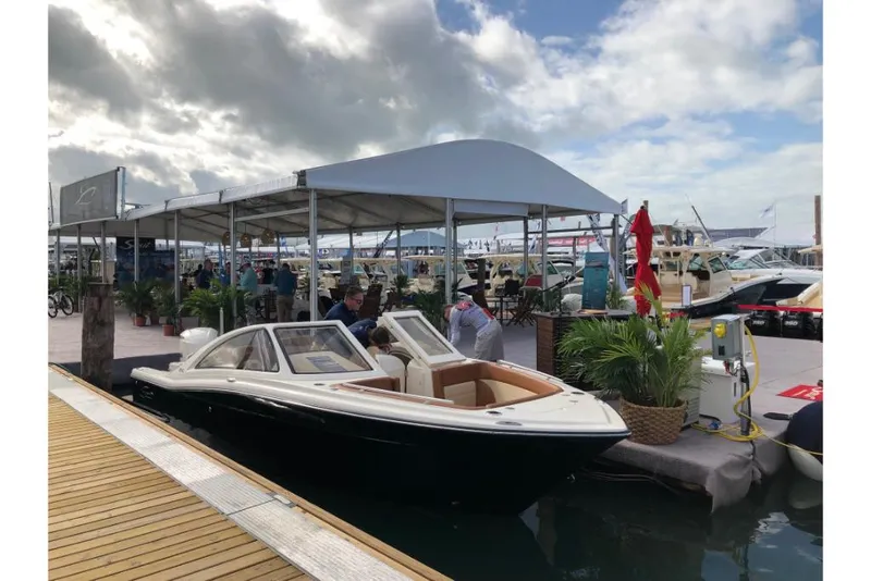 Slide: The Image of 2023 Scout 240 Dorado boat docked at marina during boat show. - 7