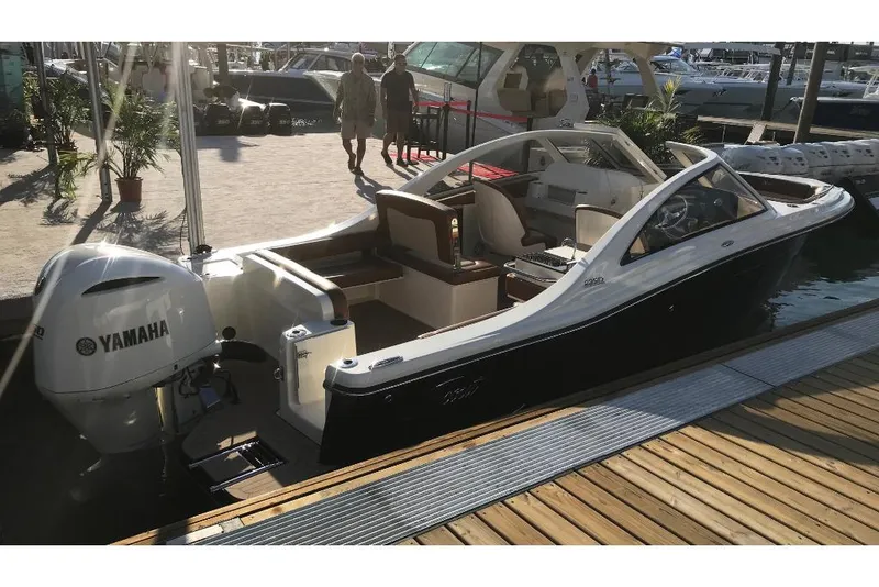 Slide: The Image of 2023 Scout 240 Dorado boat docked with Yamaha outboard motor. - 8