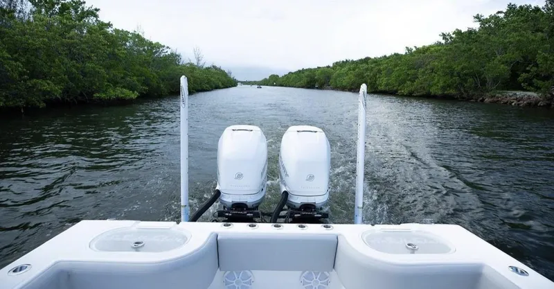Slide: The Image of Rear view of a 2021 SeaHunter 28 Floridian boat on a river. - 2