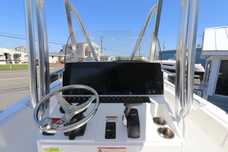 Slide: The Image of 2021 Sea Hunt Ultra 234 boat console with steering wheel and controls. - 5