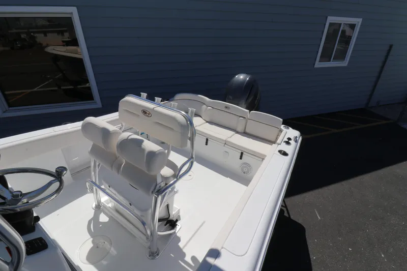 Slide: The Image of 2021 Sea Hunt Ultra 234 boat interior with seating and steering wheel. - 9