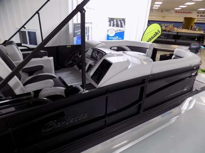 Slide: The Image of 2023 Barletta Corsa 23U pontoon boat interior with sleek black design and modern seating. - 4