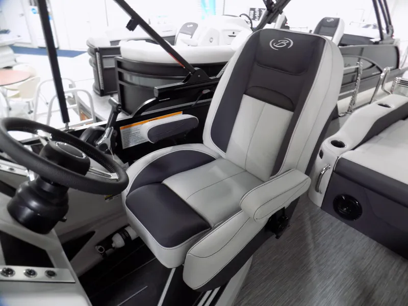 Slide: The Image of 2023 Barletta Corsa 23U boat interior with captain's chair and steering wheel. - 7