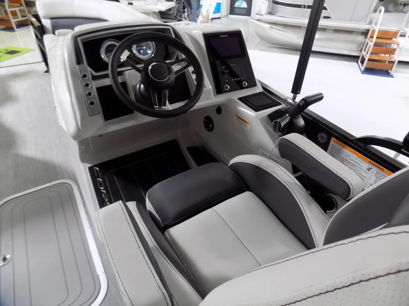 Slide: The Image of 2023 Barletta Corsa 23U boat interior with modern steering and dashboard controls. - 8