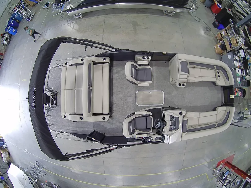 Slide: The Image of 2023 Barletta C24UC pontoon boat interior, aerial view, showcasing seating and helm layout. - 4