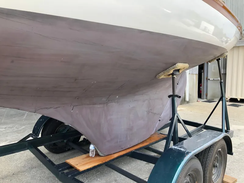 Slide: The Image of 1919 Herreshoff S Class sailboat on a trailer, undergoing maintenance. - 10