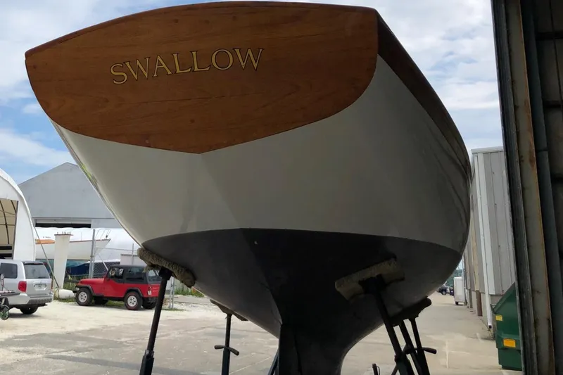 Slide: The Image of Herreshoff S Class 1919 sailboat Swallow on stands in a boatyard. - 14