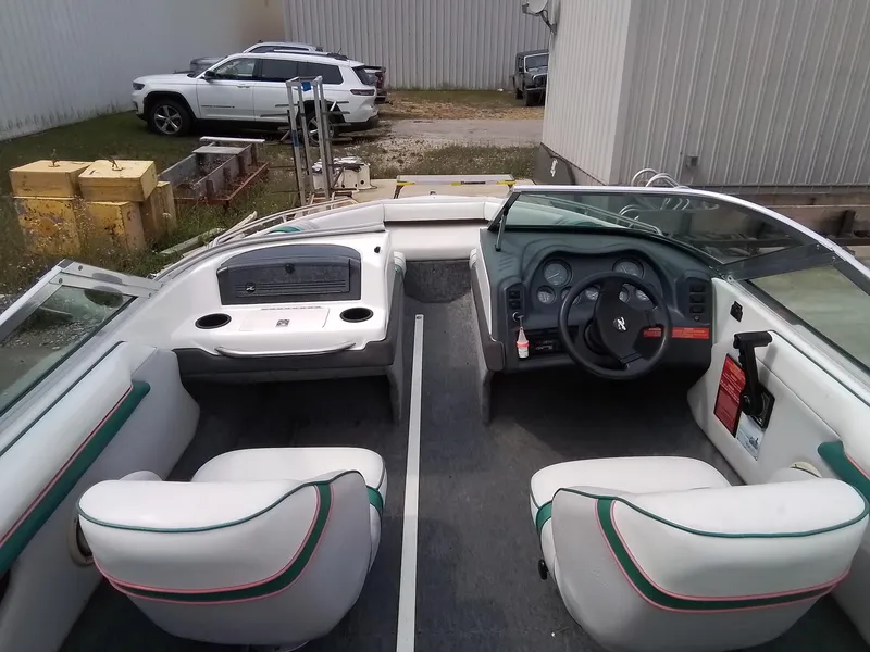 Slide: The Image of 1993 Sea Ray 180 BR boat interior with white seats and dashboard. - 12