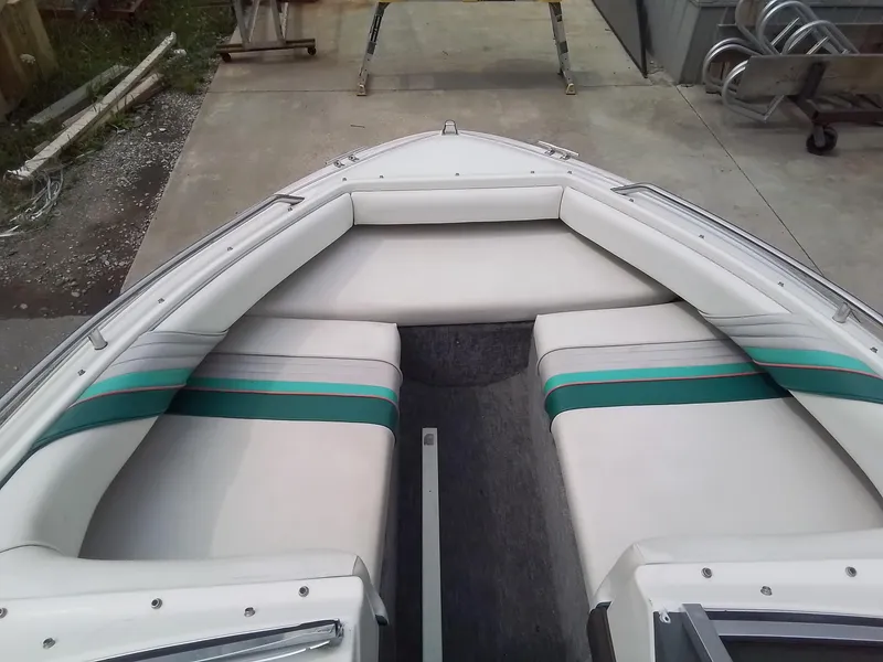 Slide: The Image of 1993 Sea Ray 180 BR boat interior with white and green seating. - 13