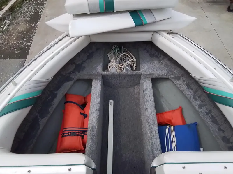 Slide: The Image of 1993 Sea Ray 180 BR boat interior with life jackets and ropes. - 14