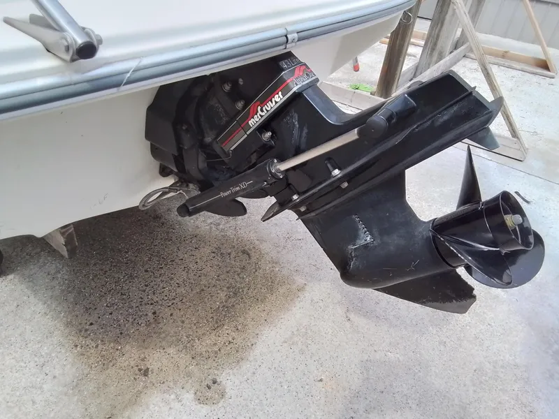 Slide: The Image of 1993 Sea Ray 180 BR boat with MerCruiser outboard motor, shown on concrete surface. - 9