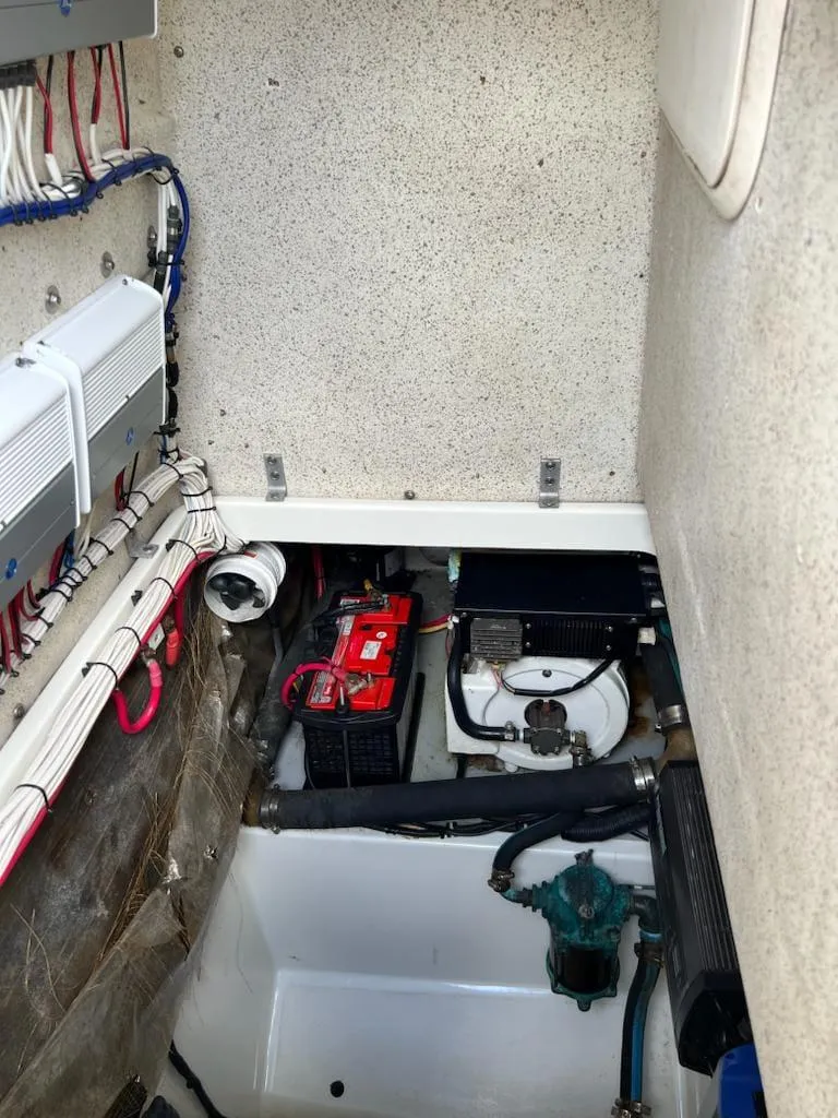 Slide: The Image of 2005 Hydra-Sports 3300 VX engine compartment with wiring and battery. - 14