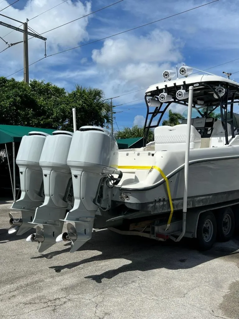 Slide: The Image of 2005 Hydra-Sports 3300 VX boat with triple outboard engines on trailer. - 15