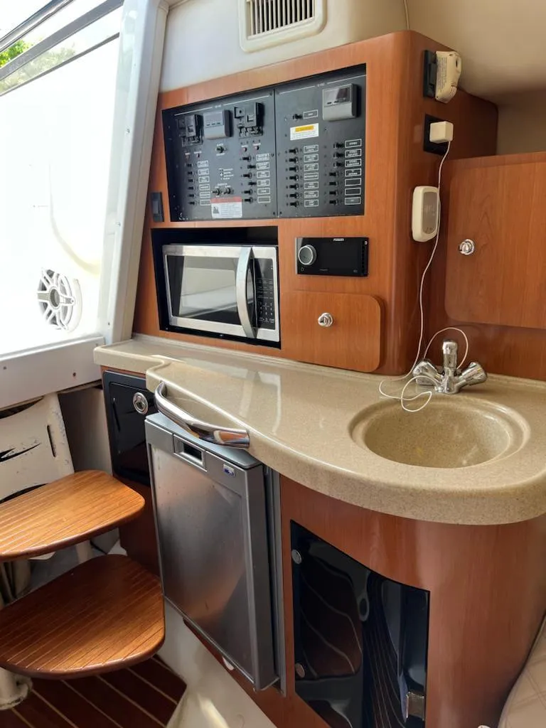 Slide: The Image of 2005 Hydra-Sports 3300 VX boat interior with kitchenette and control panel. - 22
