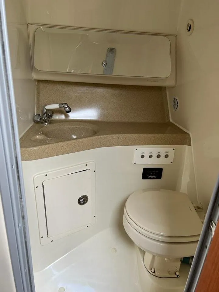 Slide: The Image of 2005 Hydra-Sports 3300 VX boat bathroom with sink, mirror, and toilet. - 24