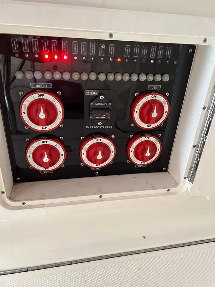 Slide: The Image of Control panel of a 2005 Hydra-Sports 3300 VX boat with red switches. - 26