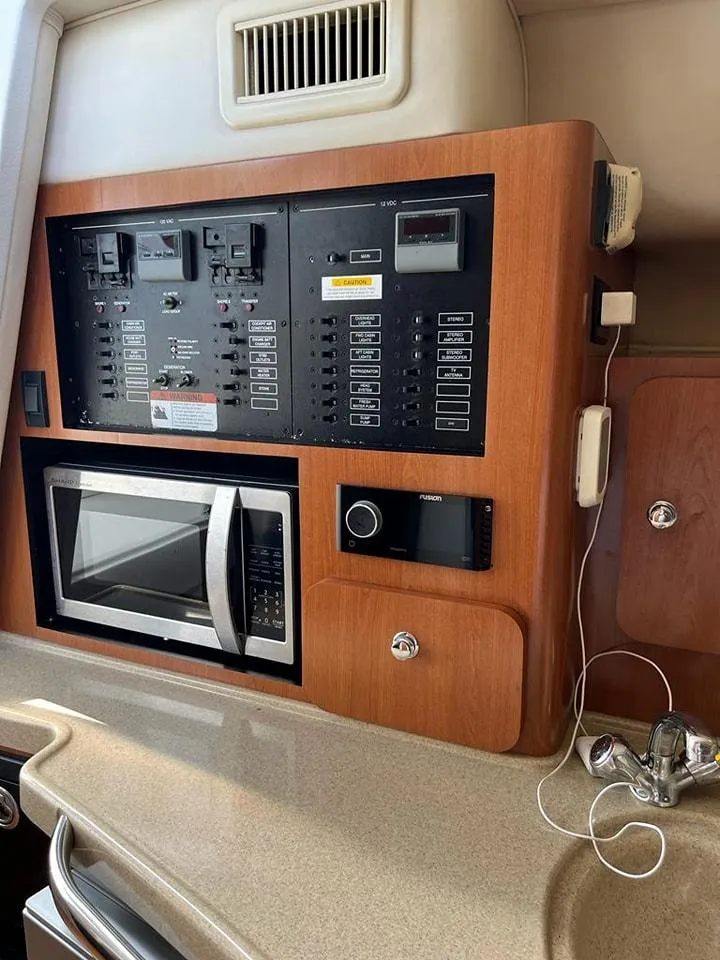 Slide: The Image of Control panel and microwave in 2005 Hydra-Sports 3300 VX boat interior. - 28