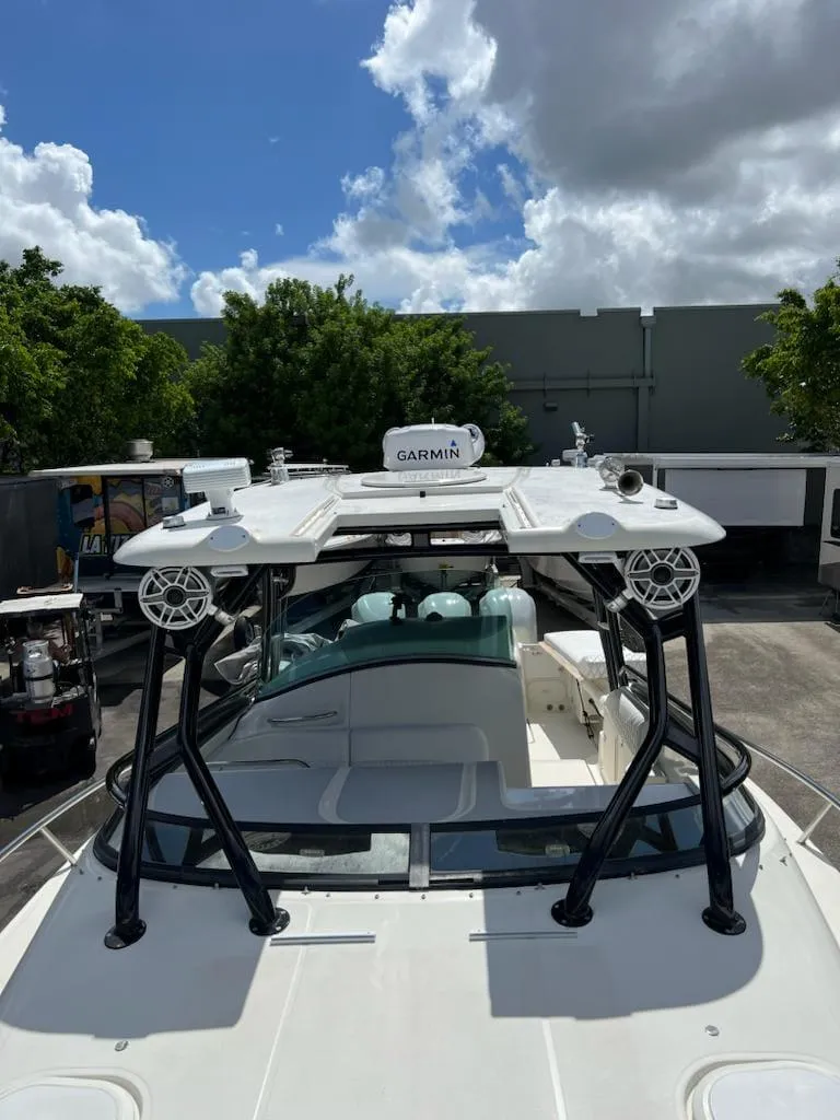 Slide: The Image of 2005 Hydra-Sports 3300 VX boat with Garmin radar, docked under cloudy sky. - 7