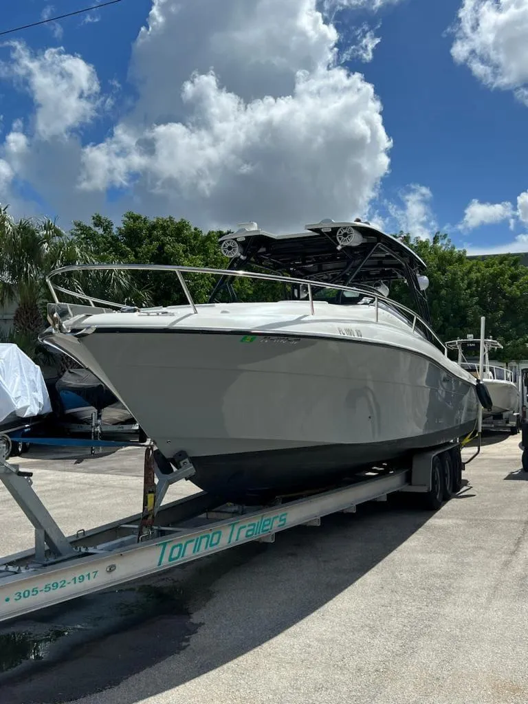 Slide: The Image of 2005 Hydra-Sports 3300 VX boat on Torino Trailers in sunny marina. - 8
