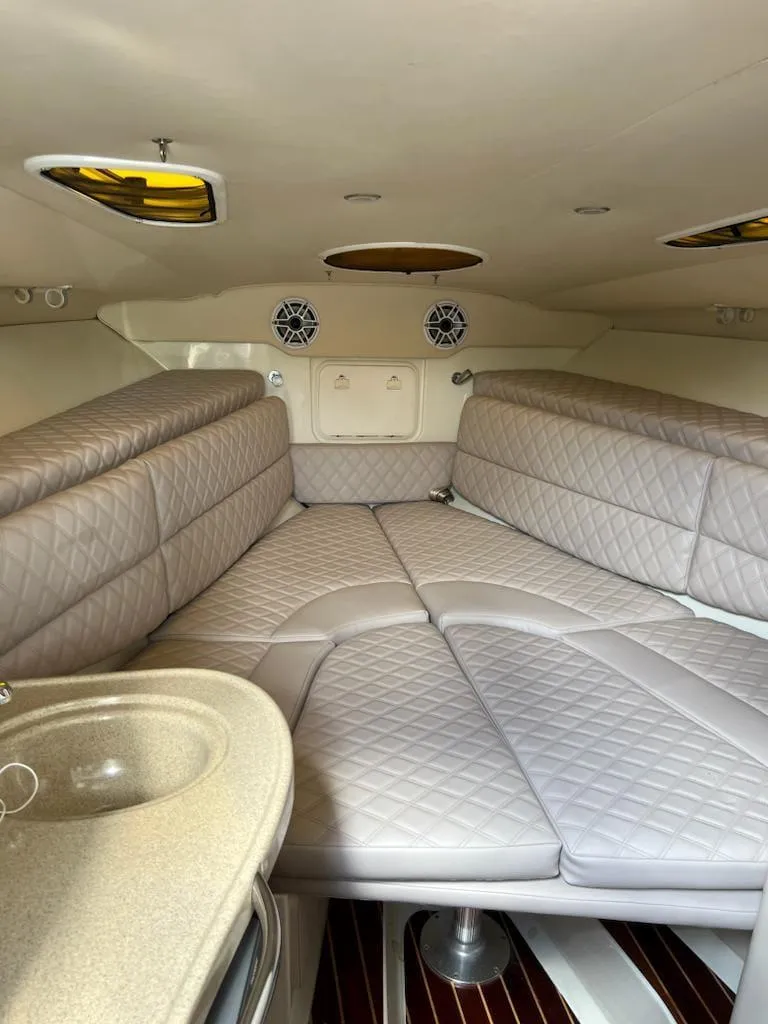 Slide: The Image of 2005 Hydra-Sports 3300 VX cabin interior with cushioned seating and sink. - 9