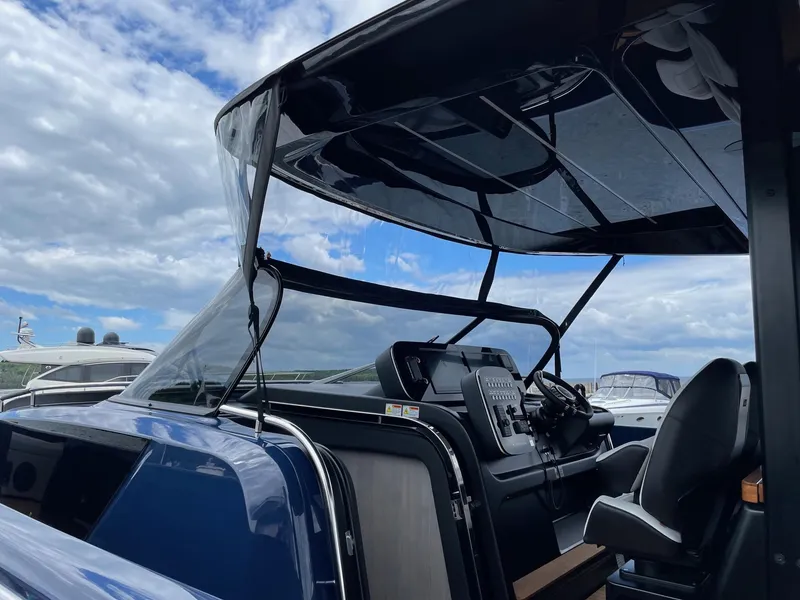 Slide: The Image of 2024 Cranchi A46 yacht cockpit with modern controls under a clear sky. - 10