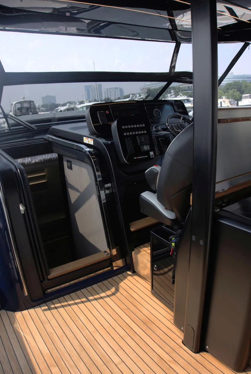 Slide: The Image of Interior view of 2024 Cranchi A46 yacht cockpit with modern controls and seating. - 11