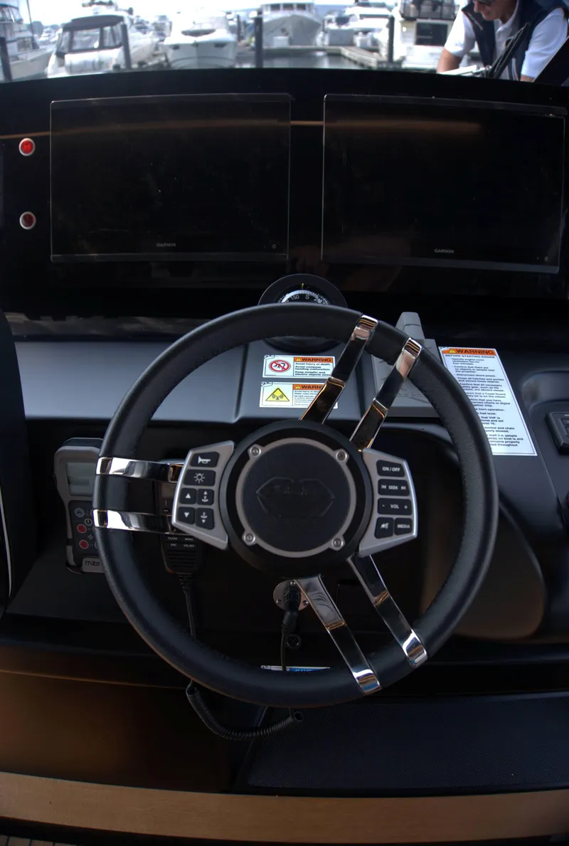 Slide: The Image of Steering wheel and dashboard of 2024 Cranchi A46 yacht, featuring modern controls and displays. - 13